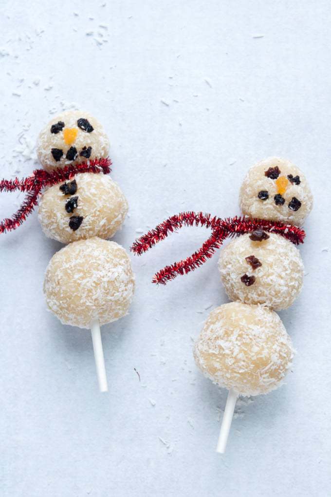 Coconut almond energy balls made into Christmas snowmen! These treats on sticks are easy and fun to make. 