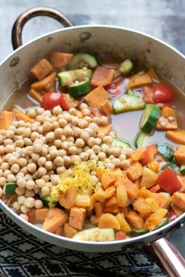 vegetables and chickpeas in a pan cooking
