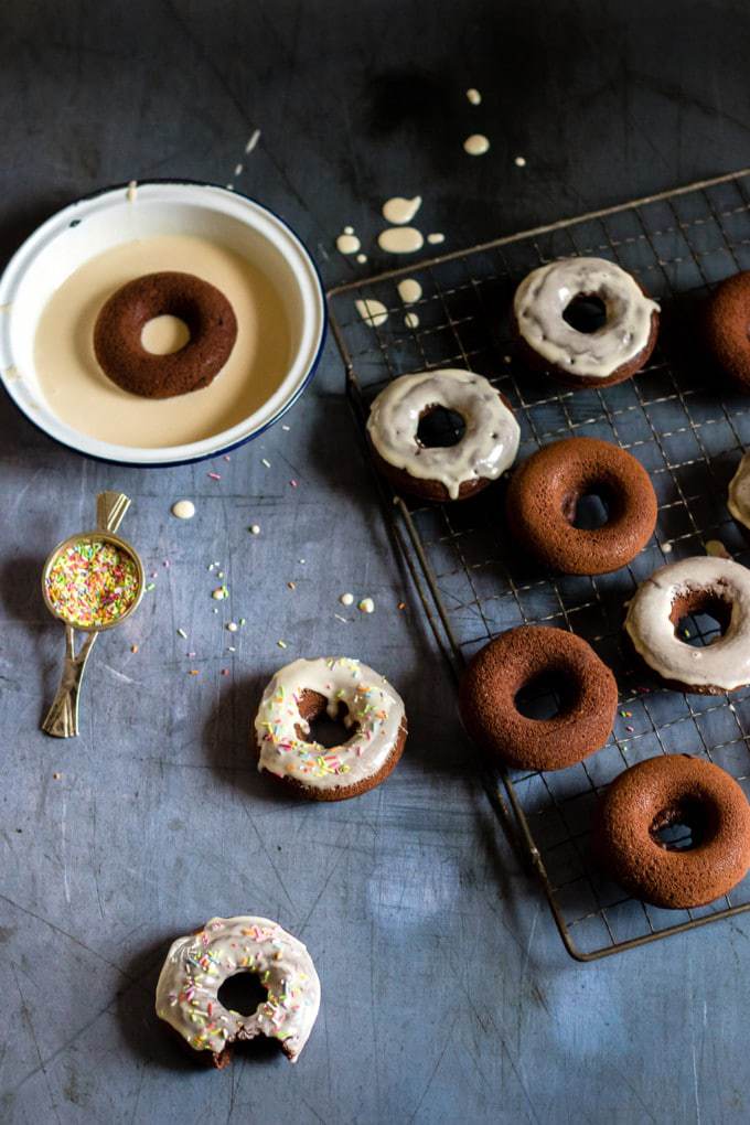 Donuts on a wire rack, with some covered in glaze.