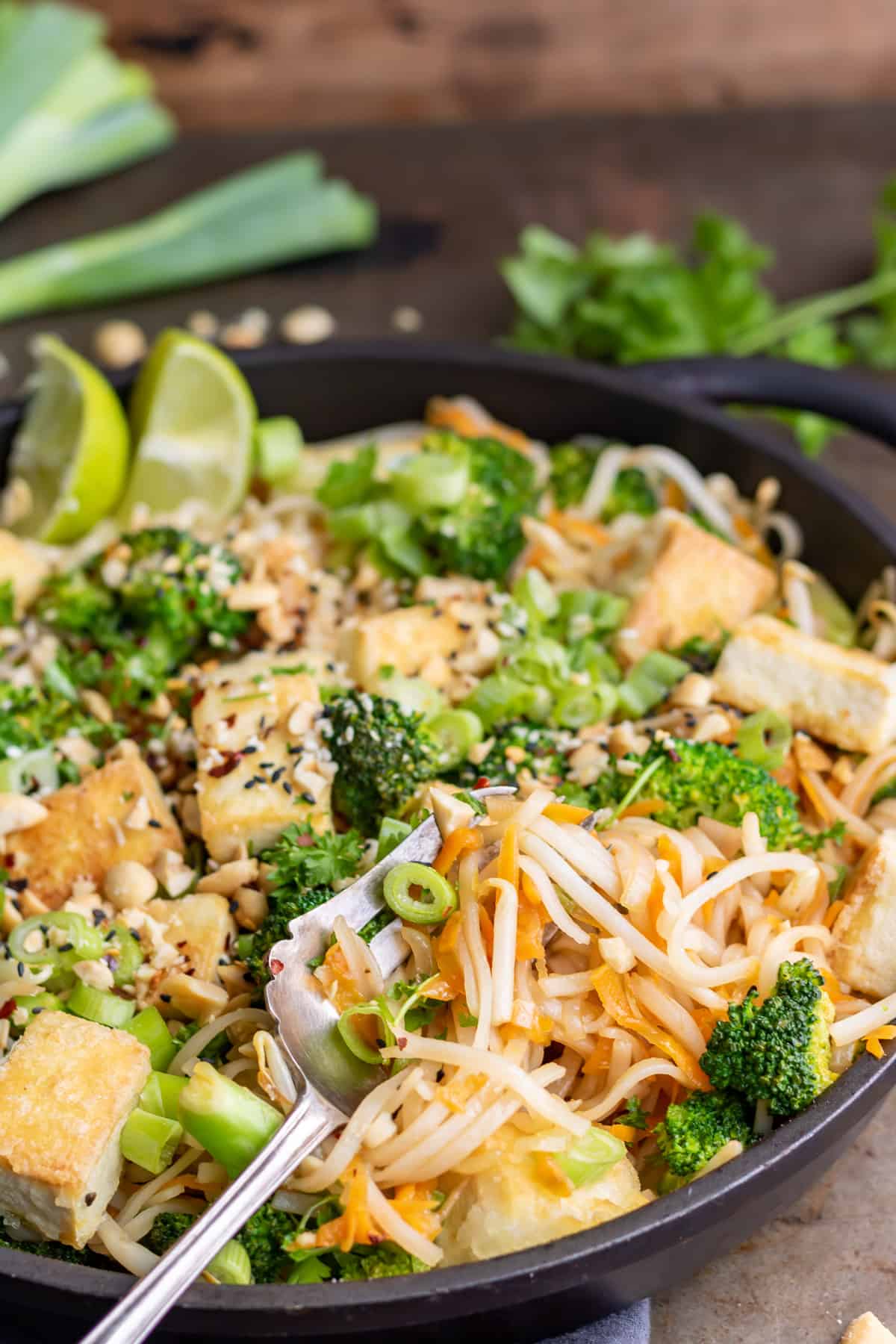 Fork in a dish of pad thai.