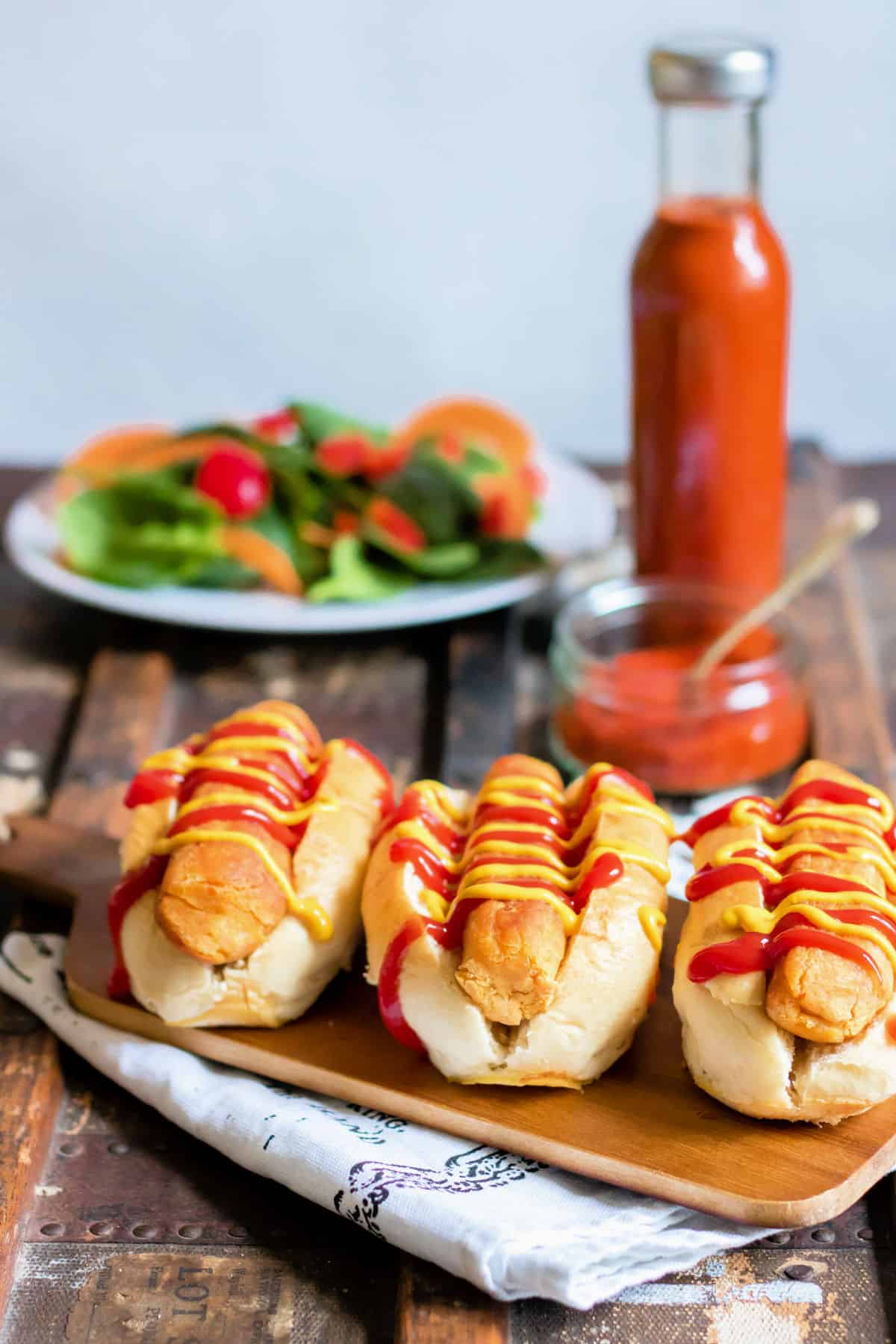 Table with a board of lentil hot dogs.