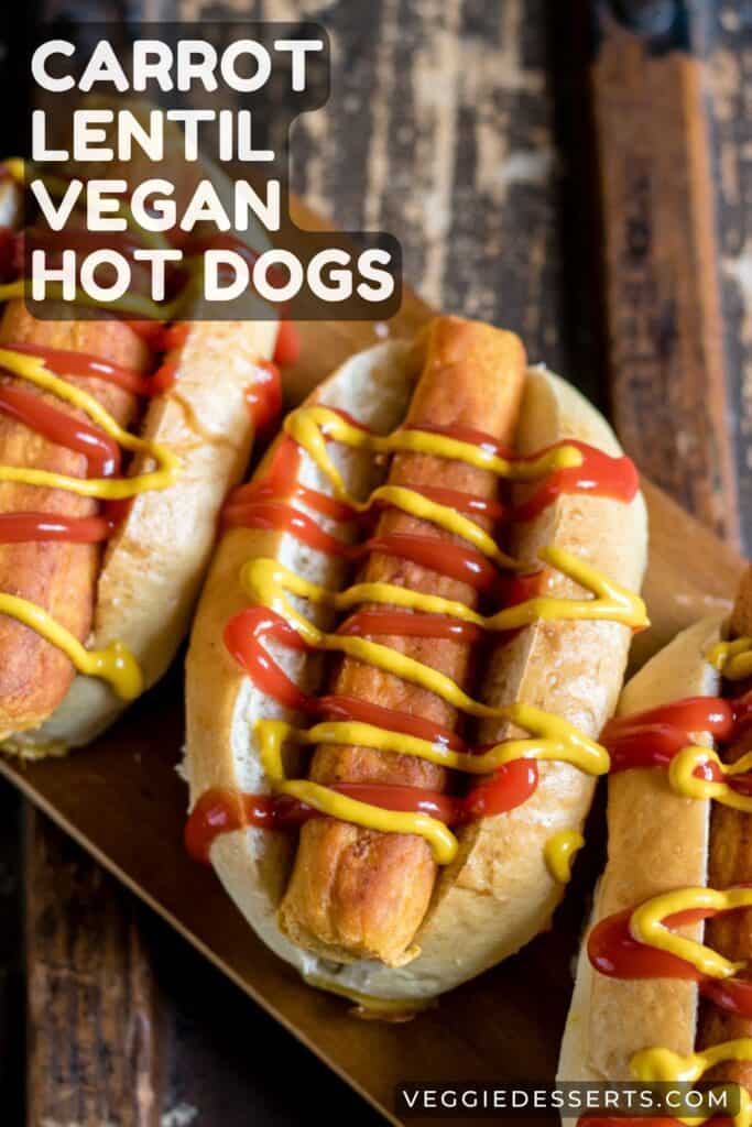 Hot dogs on a table with text: Carrot Lentil Vegan Hot Dogs.