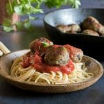 A plate of spaghetti and vegan meatballs.