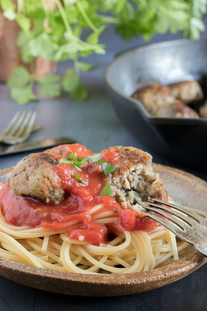 A plate of spaghetti and (aubergine) eggplant meatballs (vegan) with tomato sauce. 