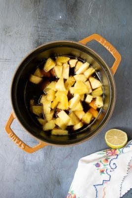 How to make pineapple compote - step 3: Reduce the heat, add the pineapple chunks and simmer for 15 minutes to reduce slightly.