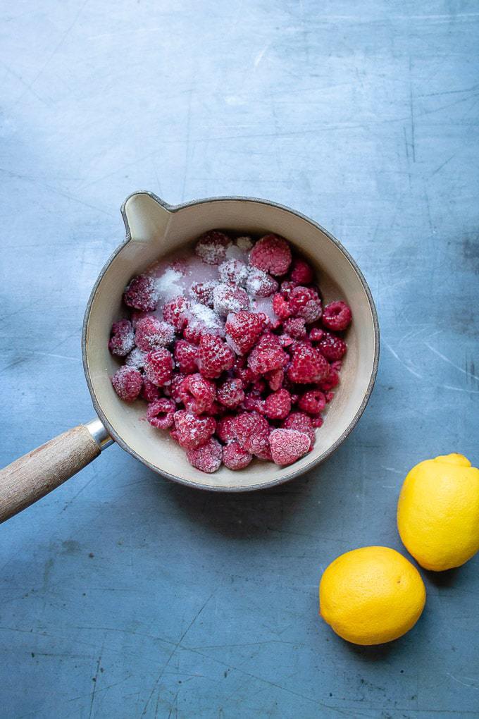 Pot of raspberries and sugar.