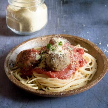 A plate of spaghetti and vegan eggplant meatballs.