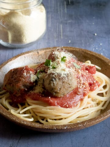 A plate of spaghetti and vegan eggplant meatballs.