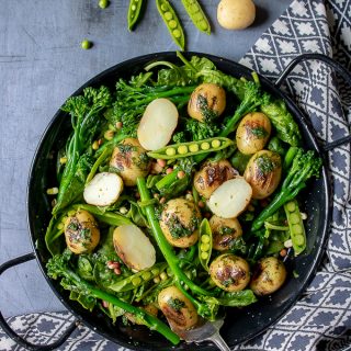 A bowl of fresh, healthy and tasty broccoli salad with peas, potatoes and herb dressing. Vegan, dairy free, gluten free.