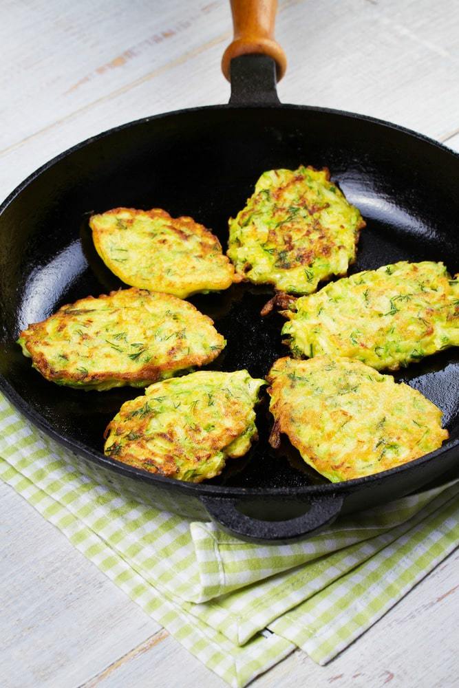 Frying fritters in a skillet.