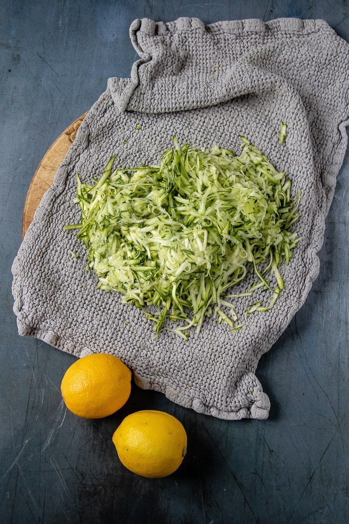 Grated courgette in a tea towel.