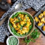 Plate of turmeric roasted cauliflower on a table.