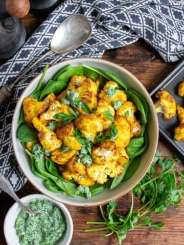 Plate of turmeric roasted cauliflower on a table.