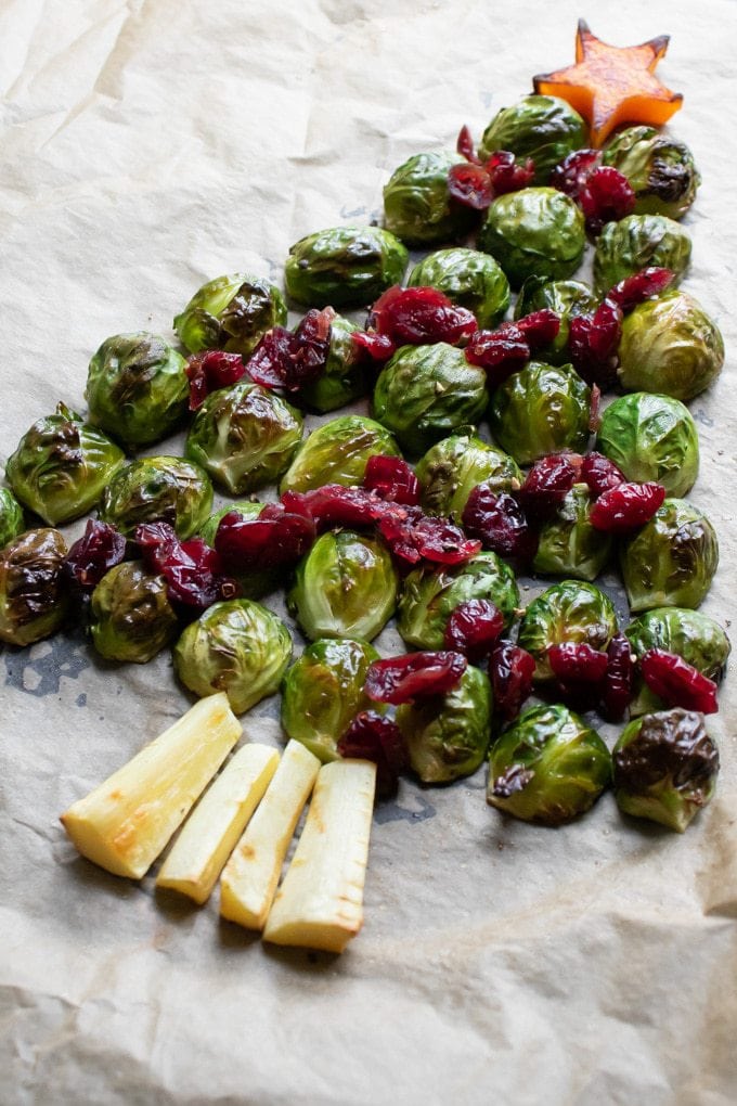 Roasted brussels sprouts in the shape of a tree on a baking tray.