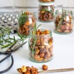 Small jars of maple rosemary spiced roasted nuts.