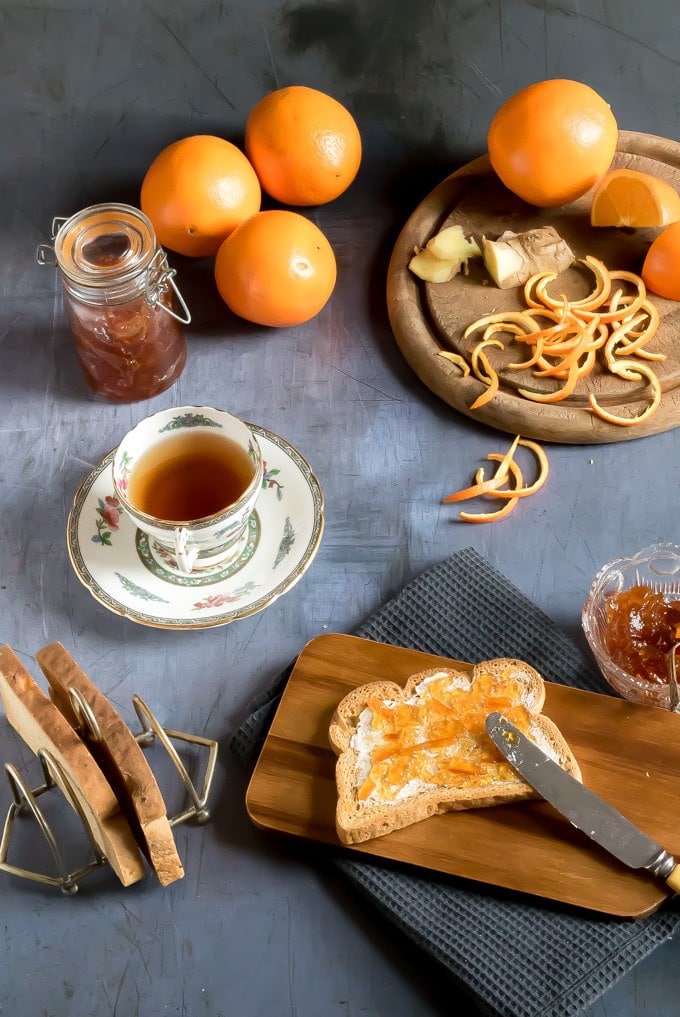 Easy ginger and orange marmalade recipe. Shown being spread on toast next to a cup of tea