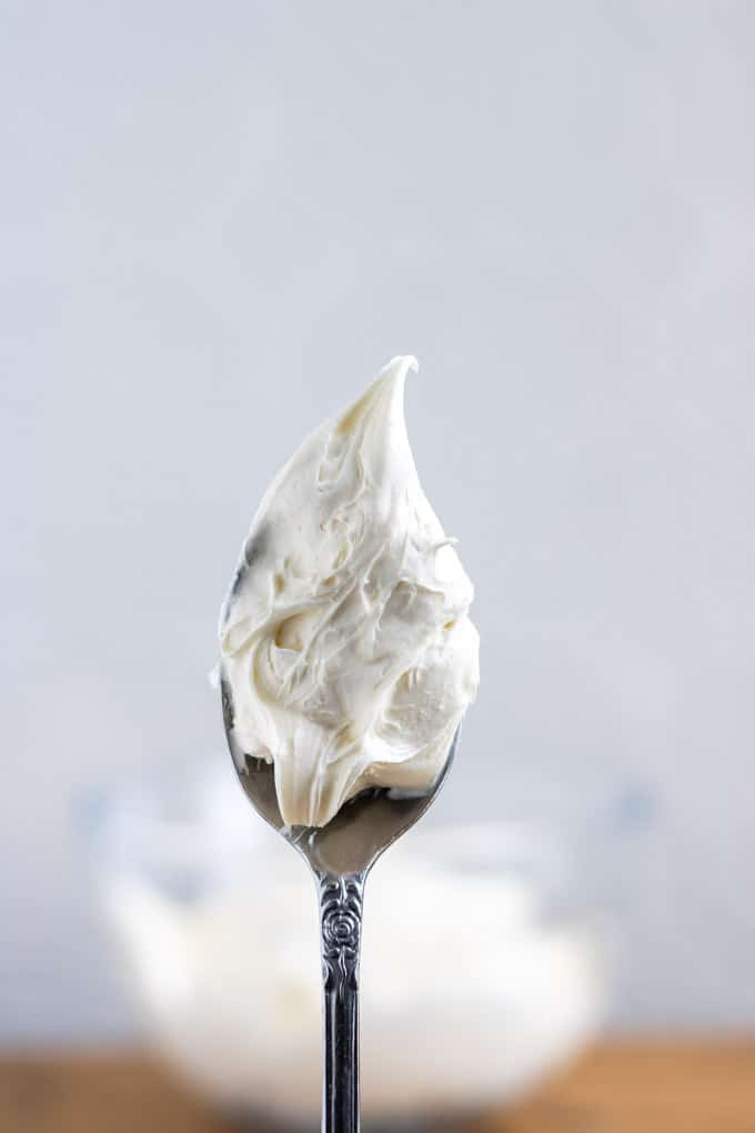 A vintage spoon held upright with a thick swirl of fluffy vegan cream cheese frosting. Get the recipe. 