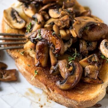 Mushrooms on toast with a fork.