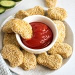 Baked vegan chicken nuggets (an easy 6 ingredient, 30 minute, soy free recipe). A plate of chickpea nuggets with a bowl of ketchup.