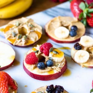 Sliced apples topped with fruit.