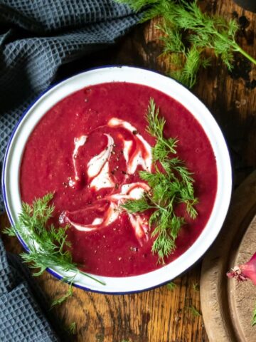 Bowl of beet soup with dill.