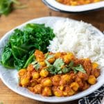 A plate of delicious vegan chickpea curry, shown with rice and steamed kale. 20 minute recipe.