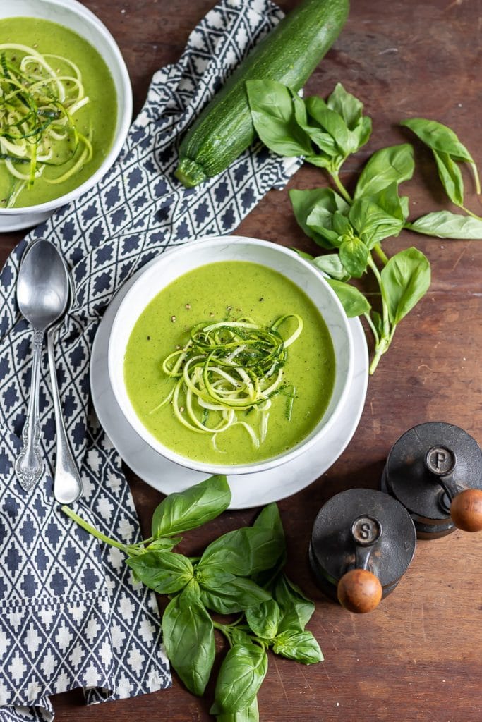 Bowl of soup on the table with basil.