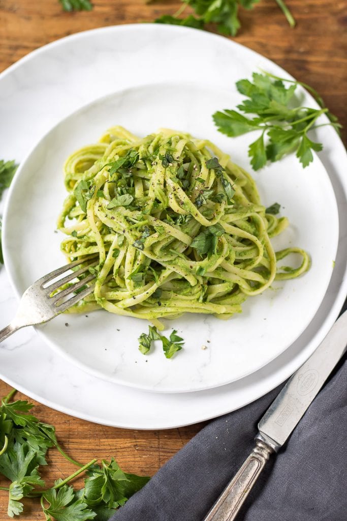 View down of plate with green spaghetti - pasta with avocado herb sauce