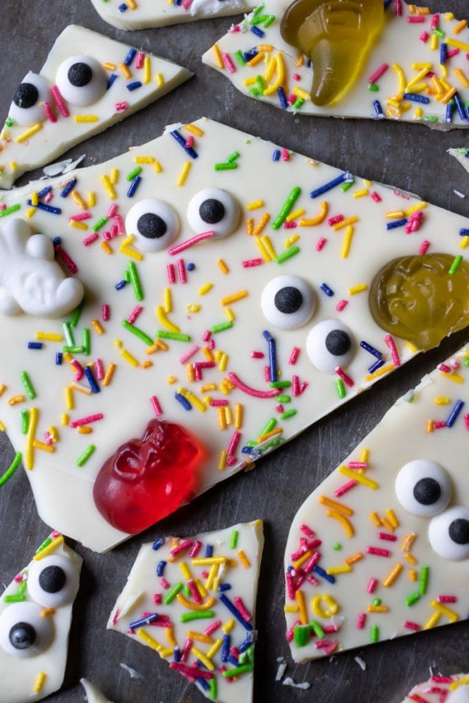 Close up of a piece of Halloween bark - white chocolate with candy eyes, sprinkles and candies