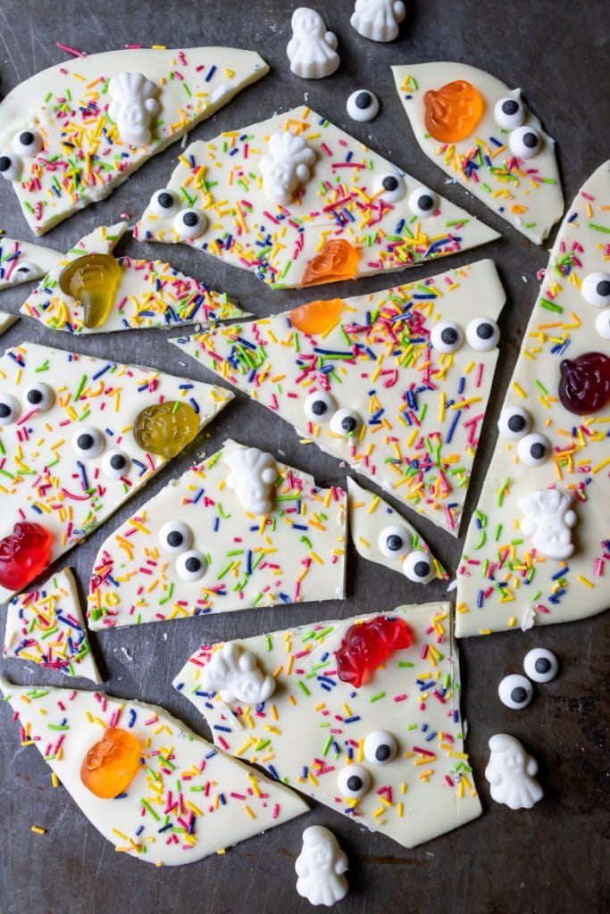 Shards of white chocolate bark with sprinkles, candy eyes and halloween candy.