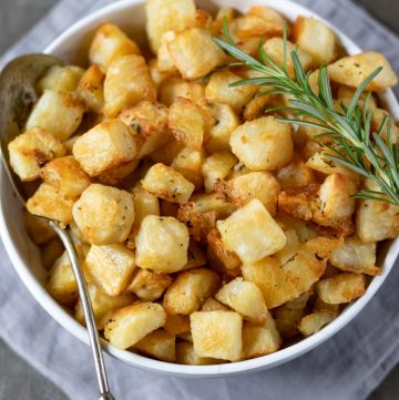 Overhead shot of a bowl of diced cubed Parmentier Potatoes - a French vegan potato side dish recipe.