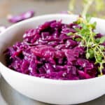 Bowl of braised red cabbage on a table.
