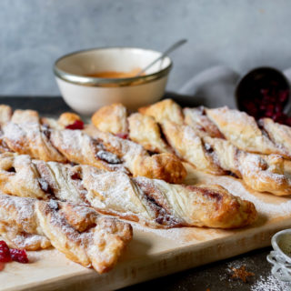 Cinnamon puff pastry twists on a wooden board