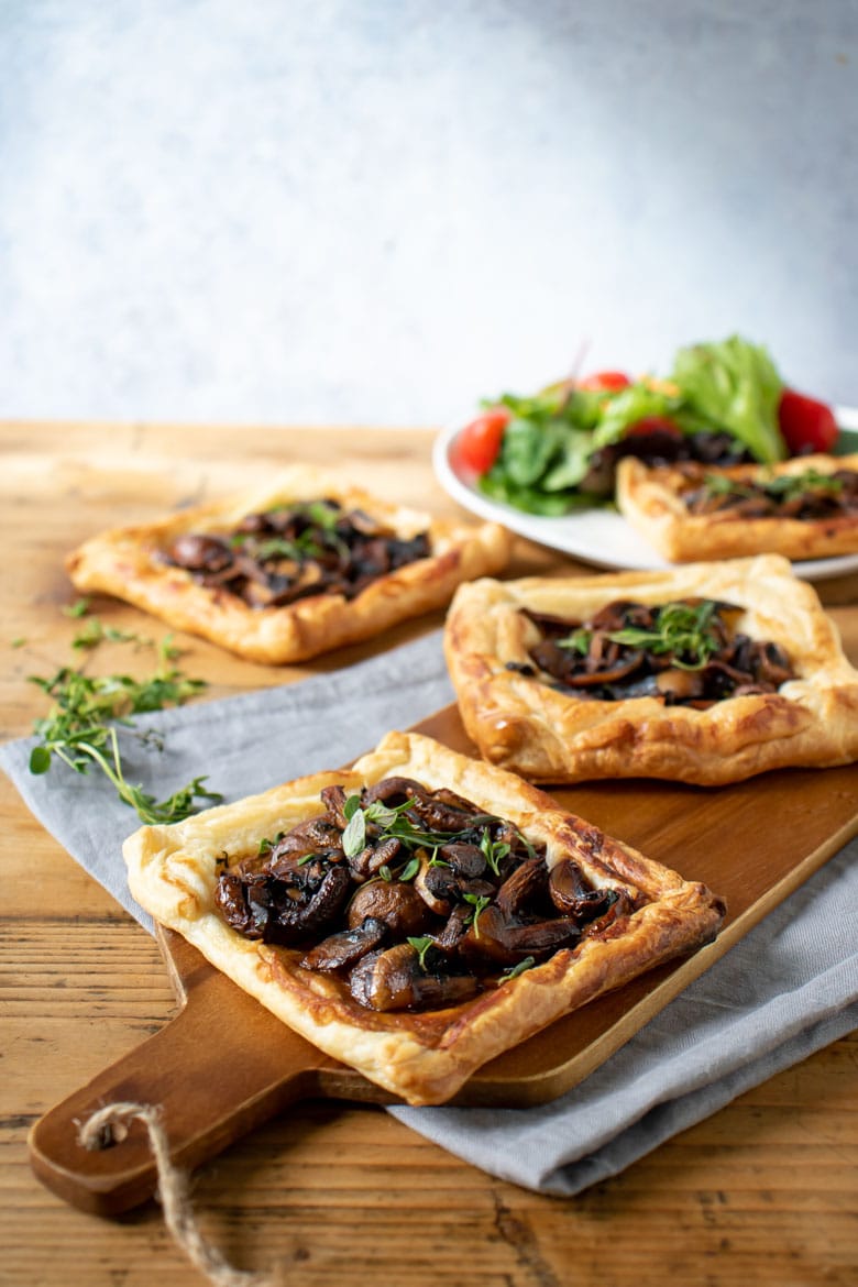 A wooden table with mushroom pastries - a dinner or appetizer. 