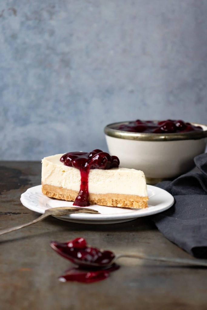 A slice of cheesecake with berry topping.