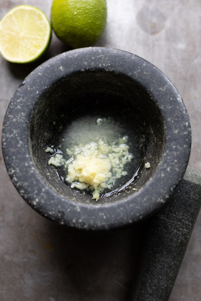 Garlic, lemon juice and salt in a pestle and mortar.