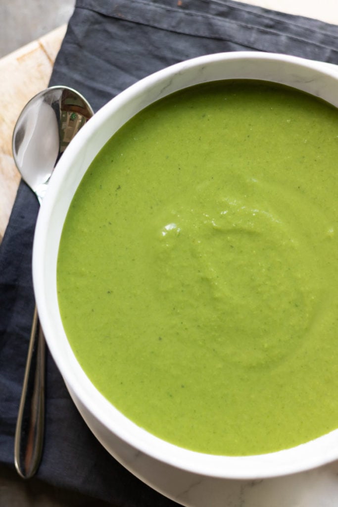 Close up of a bowl of pea soup.
