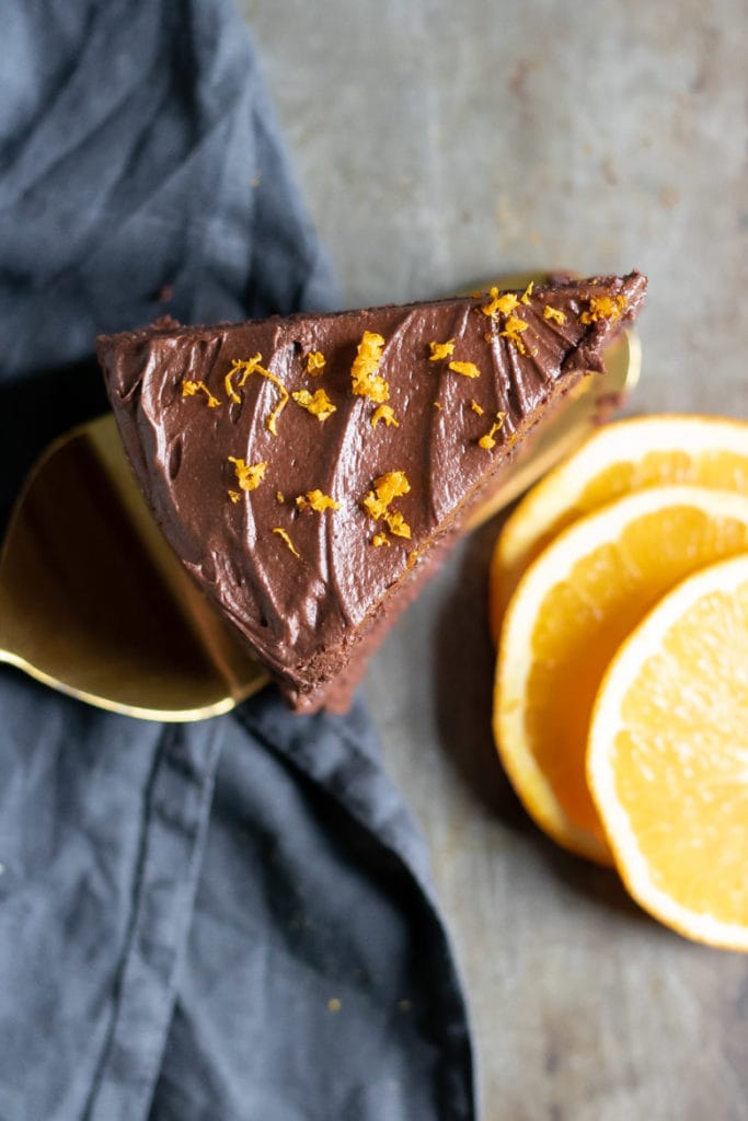 Overhead shot of a slice of Chocolate Orange Cake with orange zest on the frosting.
