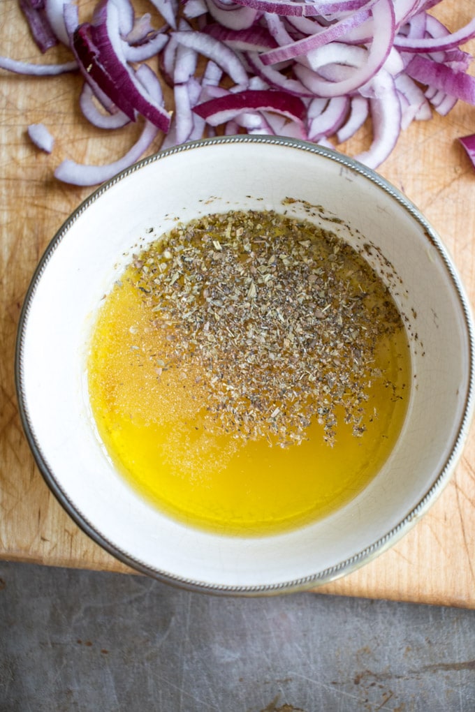 Oil and herbs in a bowl.