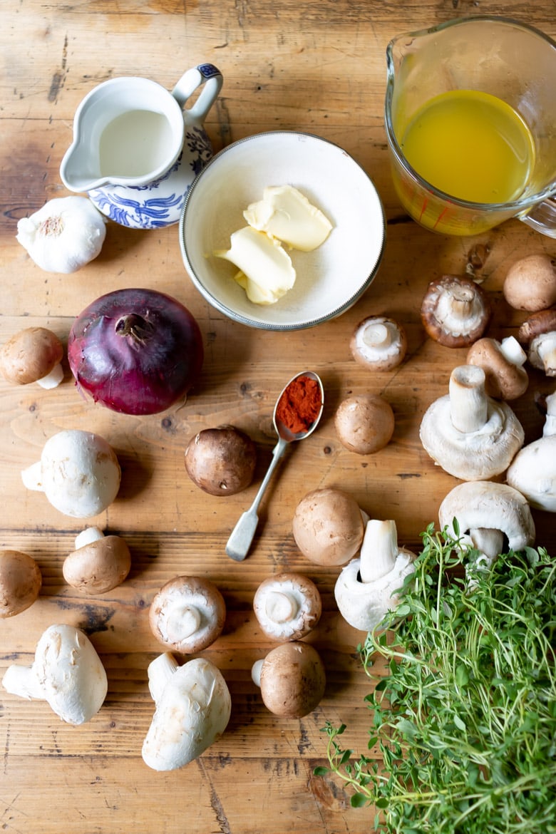 Ingredients for mushroom stroganoff on wooden table