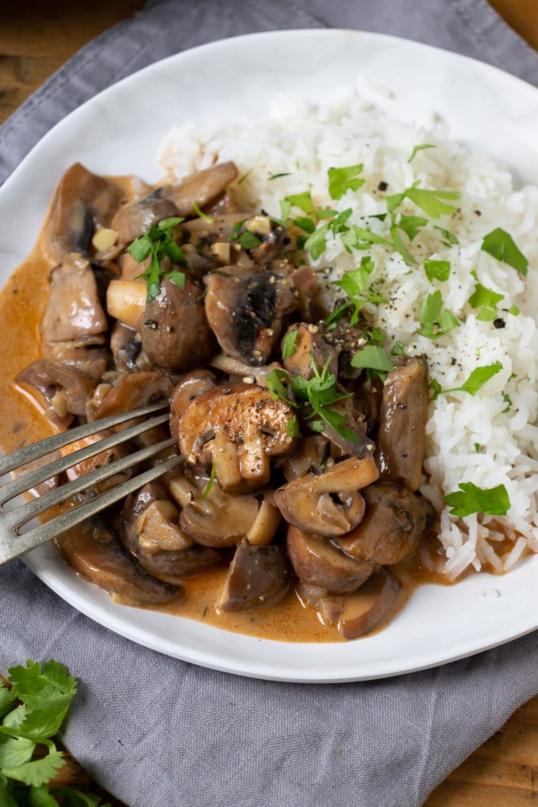 Close up of plate of mushroom vegan stroganoff with rice.