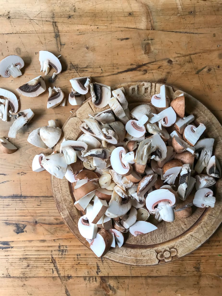 Chopped mushrooms on a chopping board.