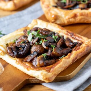 Mushroom tarts on a wooden board.