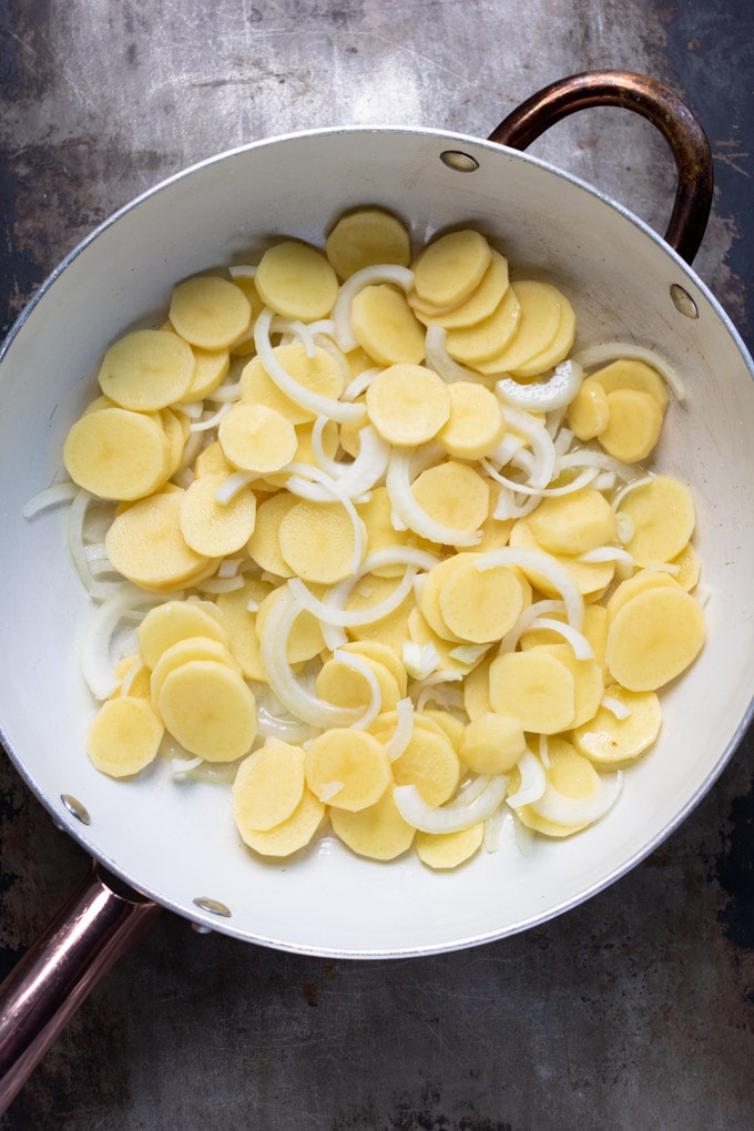 Skillet of onions and potatoes.