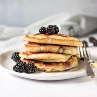 Stack of pancakes with blackerries.