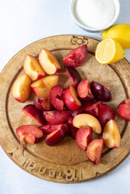 Chopped plums on a wooden board.