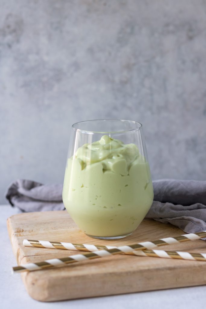 Glass of green avocado milkshake.