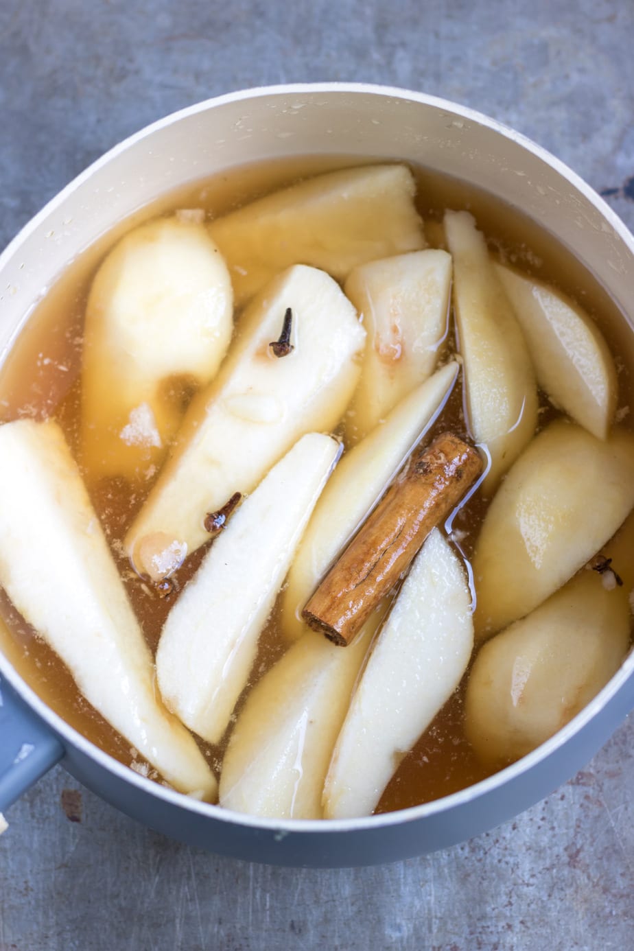 Pot of pears, cinnamon stick and cloves.