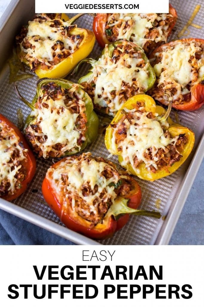 Tray of cooked stuffed peppers. Text overlay reads: Easy vegetarian stuffed peppers.
