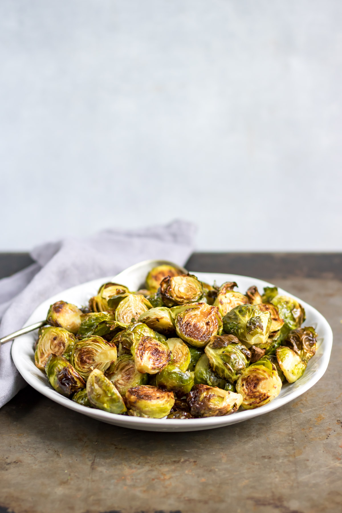 Serving plate of roasted balsamic sprouts.